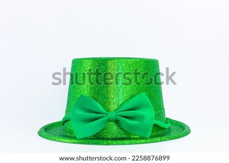 Green Leprechaun hat with glitter and a bow isolated on a white background for Irish St. Patrick's Day holiday and Carnival. Horizontal costume accessory banner with copy space. 