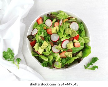 Green lettuce salad with fresh vegetables isolated on white background. - Powered by Shutterstock