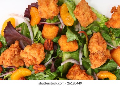 Green Lettuce Salad With Fried Chicken, Red Onions, Spicy Pecans, Cornbread Croutons And Tangerines.