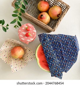 Green Lifestyle With Beeswax Food Wraps To Keep Food Fresh. Watermelon And Pomegranate In Cotton Fabric Wrap. A Glass Jar With Beeswax Cover. Plastic-free Living.