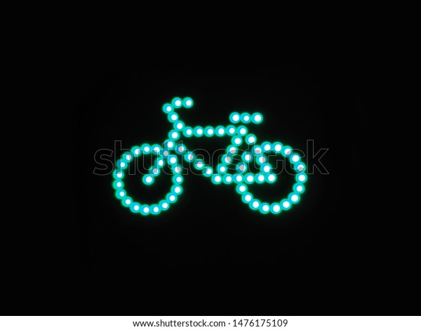 Green light for bicycle lane on traffic light.
Night bike traffic signal
