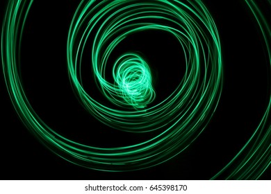 Green Light Painting Photography Swirl Against A Black Background