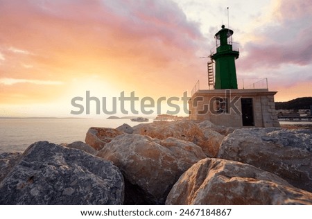 Green lighthouse on the shore in Split, Croatia on sunset