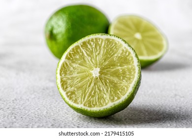 Green lime with cut in half and slices isolated on white background.Healthy green foods - alternative medicine involve a balanced diet with vitamins, nutritions and superfoods for human well-being. - Shutterstock ID 2179415105
