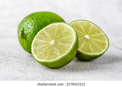 Green lime with cut in half and slices isolated on white background.Healthy green foods - alternative medicine involve a balanced diet with vitamins, nutritions and superfoods for human well-being. - Shutterstock ID 2179415111