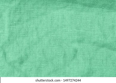 Green linen fabric background. COLOR TREND 2020 Neo mint. Abstract new mint color background. Seafoam Green linen cloth texture. Wrinkled pure linen fabric background. Natural green  linen texture Arkivfotografi