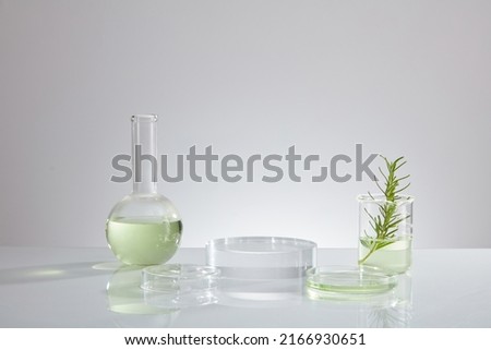 Green liquid extract from green leaf , research for develope decorated with transparent podium with laboratory equipment , chemistry research content