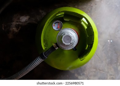 Green LPG gas cylinder with regulator installed - Shutterstock ID 2256980571