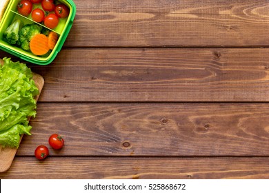 Green Lunch Box For Kid On Wooden Background Top View