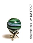 A green lutz swirl marble on jacks game piece.