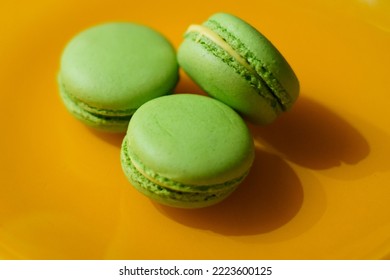 Green Macarons On The Yellow Plate