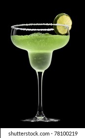 Green Margarita In Front Of A Black Background With Fresh Garnish