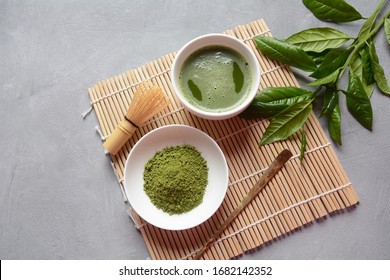 Green matcha tea drink and tea accessories on white background. Japanese tea ceremony concept. Detox tea. Antioxsidant drink