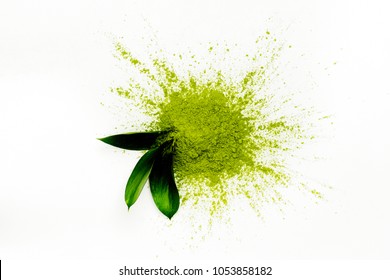 Green Matcha Tea Powder And Leaves On White Background. Copy Space