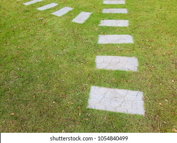 Green Meadow Divided By Rough Stone Walkway,Stamped Concrete.