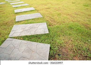 Green Meadow Divided By Rough Stone Walkway,Stamped Concrete