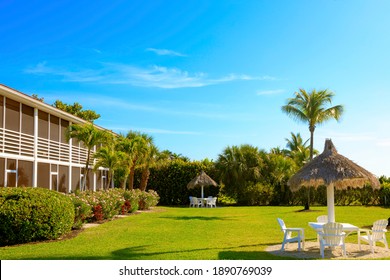 Green Meadow With Seats And Adjacent Bungalow And Bushes, Sanibel Island, Florida, USA