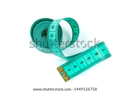 The green measuring centimetric tape curtailed by a spiral on a white background. Sewing accessories