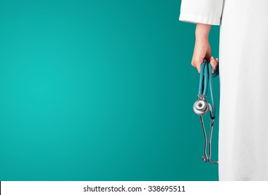 Green Medical Background With Female Doctor And Stethoscope