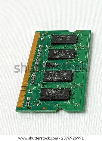 Green memory ram placed on a white background. Close -up shot of the memory ram.