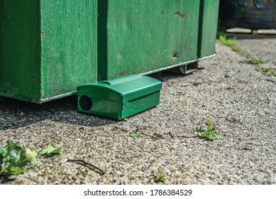 Green Metal External Rodent Rat Bait Station Outside Against A Brick Wall Close Up.  Pest Control.