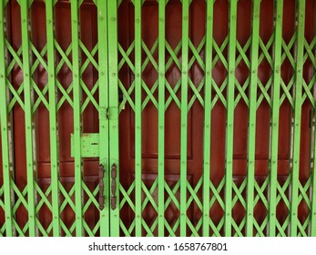 Green Metallic Retractable Door Closeup And Background, Grid Metallic Steel Lock