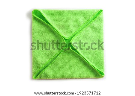 Green microfiber cloth on a white background. Cleaning cloth, napkin. Folded towel for cleaning objects and surfaces. Foto stock © 