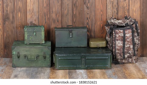 green military boxes on a wooden background	