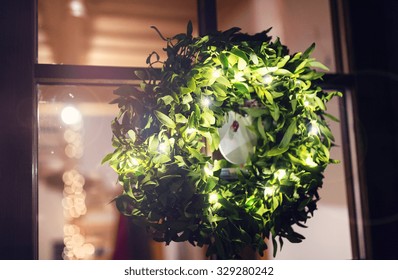 Green Mistletoe Wreath Hang On Glass Door