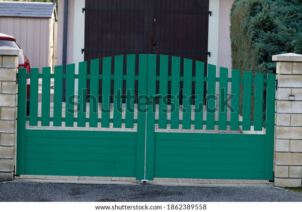 green modern house gate and garage door to access\
home garden