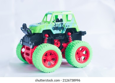 Green Monster Truck Toy Car On A White Background Isolated, More Familiar As A Boy's Toy As A Medium To Introduce Transportation To Children