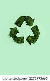 Green moss under paper cut recycling symbol. Save planet, eco, recycling concept.