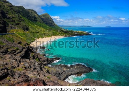 Green mountains over Makapu'u Beach Park with the translucent waters of the Pacific Ocean on the eastern side of Oahu island in Hawaii, United States