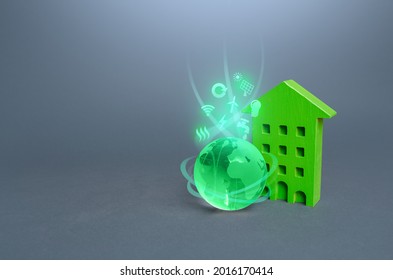 Green Multi-storey Residential Building And Globe With Environmental Symbols. High Demands, Standards Of Housing. Environmentally Friendly, Energy Efficiency, Zero Carbon Emissions. Carbon Neutrality.