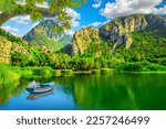 Green nature landscape in spring season. Beautiful lake landscape on colorful mountain. stunning lake view in jungle with beautiful mountains. Amazing nature scenery in the green forest in summer.