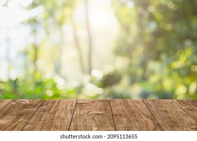 Green nature with woodden table top blur morning light forest for montage products display advertising background - Shutterstock ID 2095113655