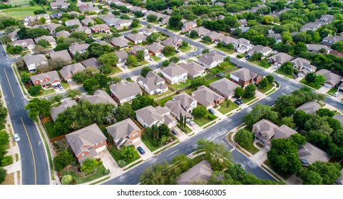 A green neighborhood Suburb houses and homes in new real estate development in Austin , Texas , USA aerial drone view at the corner of the streets - Shutterstock ID 1088460305