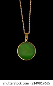 Green Nephritis Medallion Hanging On Golden Chain On Black Background