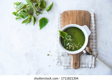 Green Nettle Leaf Soup On A White Kitchen Table. Nutrition And Vegan Food