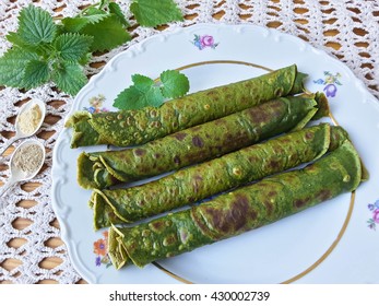 Green nettle pancakes, cooking vegetarian healthy food with wild plants