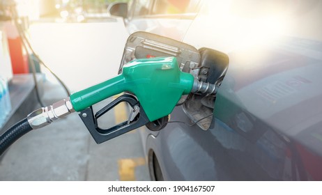 Green Nozzle Pump Gun Petrol From Oil Pump In The Car Tank To Refueling.