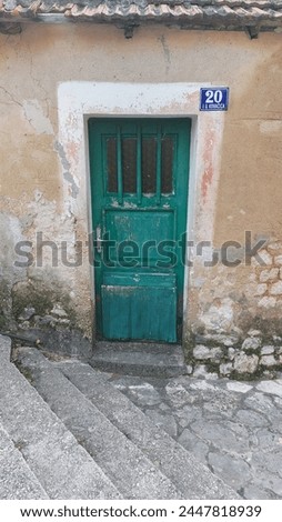 Green old door in an oldtown in croatia