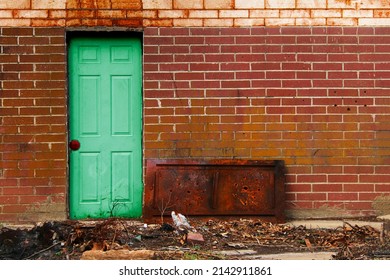 A Green Old Vintage Door Steel Red Brick Alley Wall Rusty Debris Warehouse Factory Shipping Receiving Back Door Employee Entrance