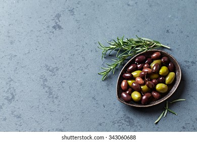 Green olives and black olives (Aragon Black Olives) in olive oil served on dark stone background. Symbolic image. Concept for a tasty and healthy appetizer. Copy space.  - Powered by Shutterstock