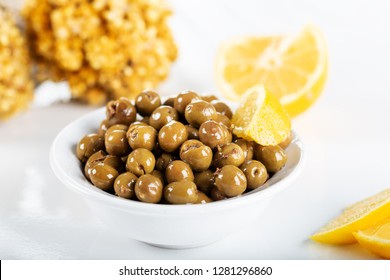 Green olives in bowl with lemon on white background. Green olives from Antakya, Turkey. - Shutterstock ID 1281296860