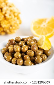 Green olives in bowl with lemon on white background. Green olives from Antakya, Turkey. - Shutterstock ID 1281296869