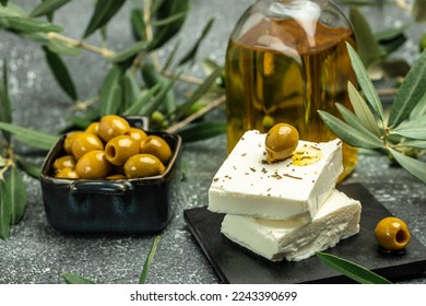 Green olives with feta cheese and young olives branch on dark background. top view. place for text. - Powered by Shutterstock