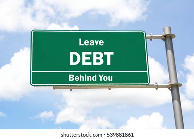 Green Overhead Road Sign With A Leave Debt Behind You Concept Against A Partly Cloudy Sky Background.