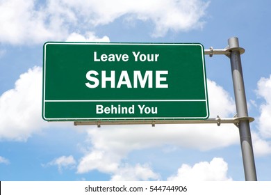 Green Overhead Road Sign With A Leave Your Shame Behind You Concept Against A Partly Cloudy Sky Background.