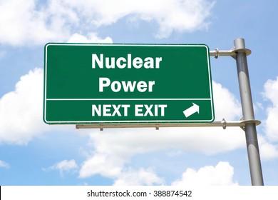 Green overhead road sign with a Nuclear Power Next Exit concept against a partly cloudy sky background.